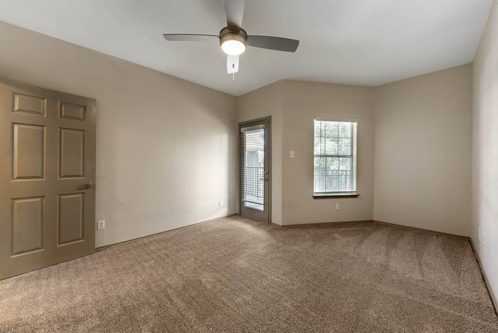 an empty room with a door and a window